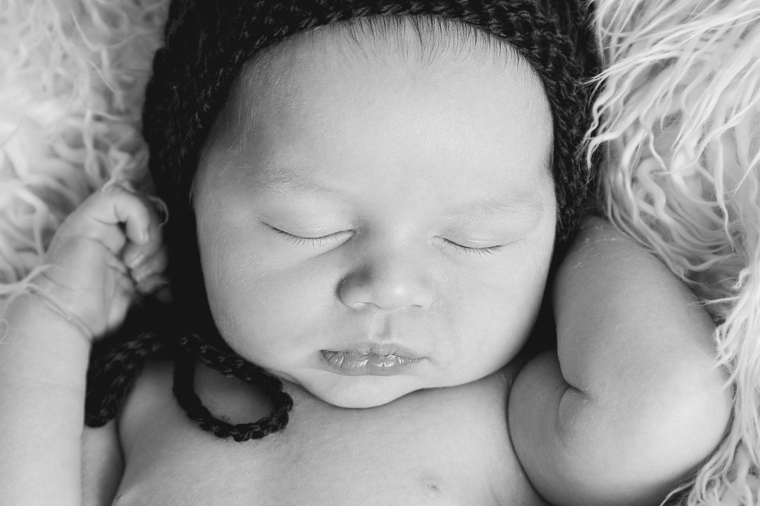 Newborn photographer Gold Coast safely posing baby in neutral wrap.