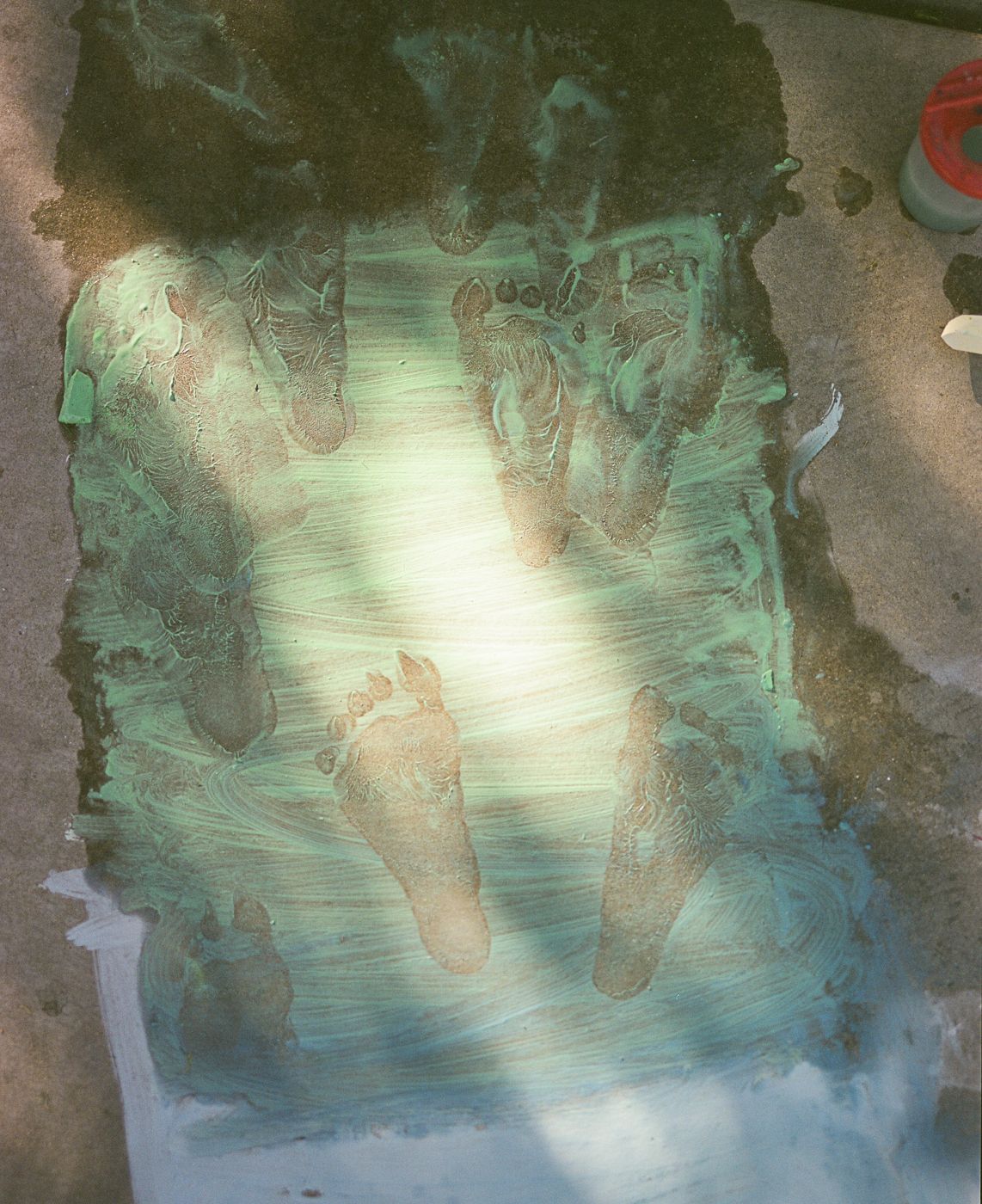 Blue and white chalk art on concrete showing a world map design.