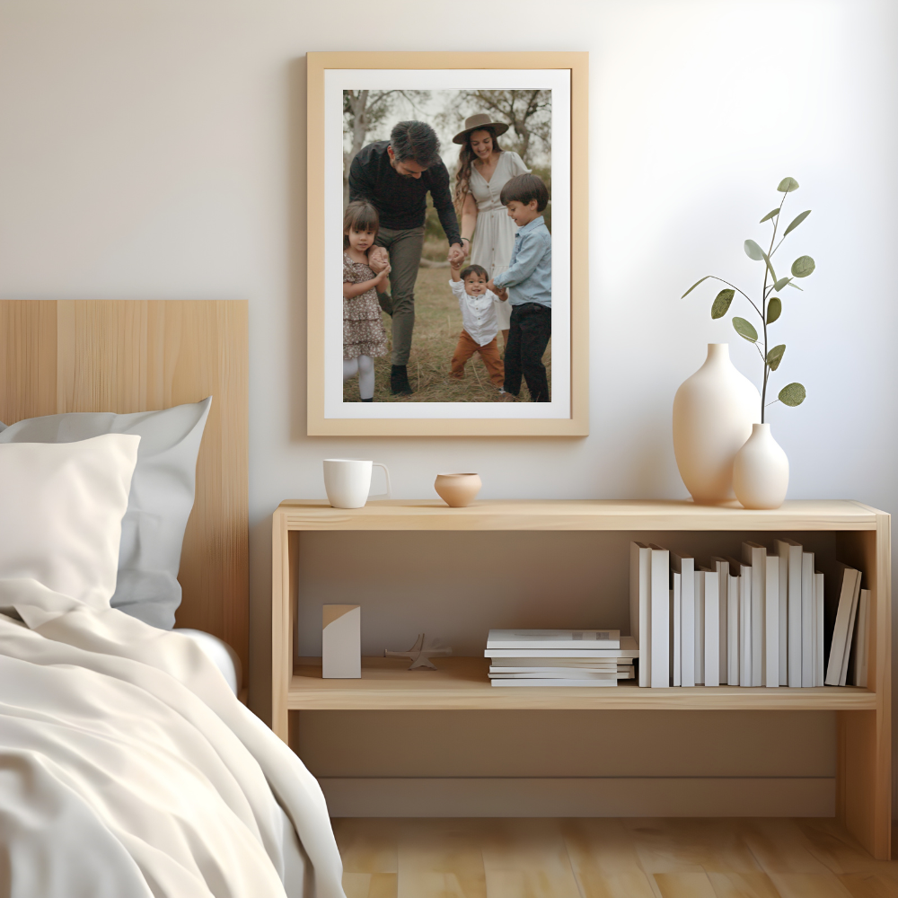 Family portrait in a frame above a shelf next to a bed