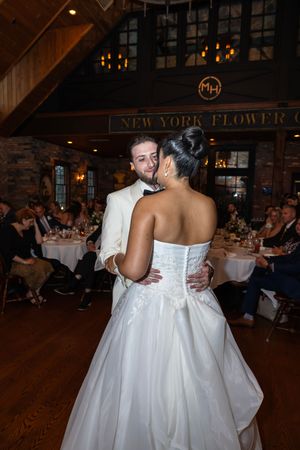 Bride and groom share an intimate dance at their wedding reception in a rustic New York venue. Bergen County Wedding Photographer