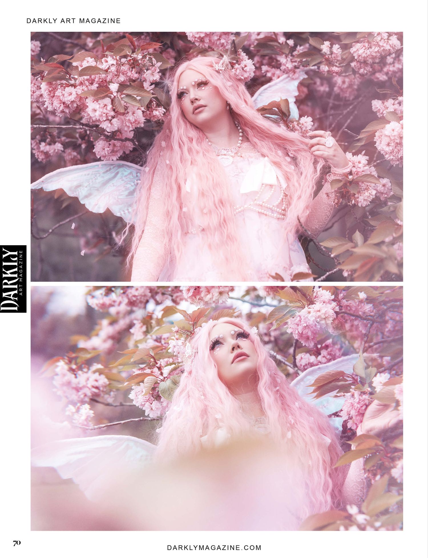 A woman dressed as a fairy with pink hair and wings, standing among pink blossoms. The image is from Darkly Art Magazine