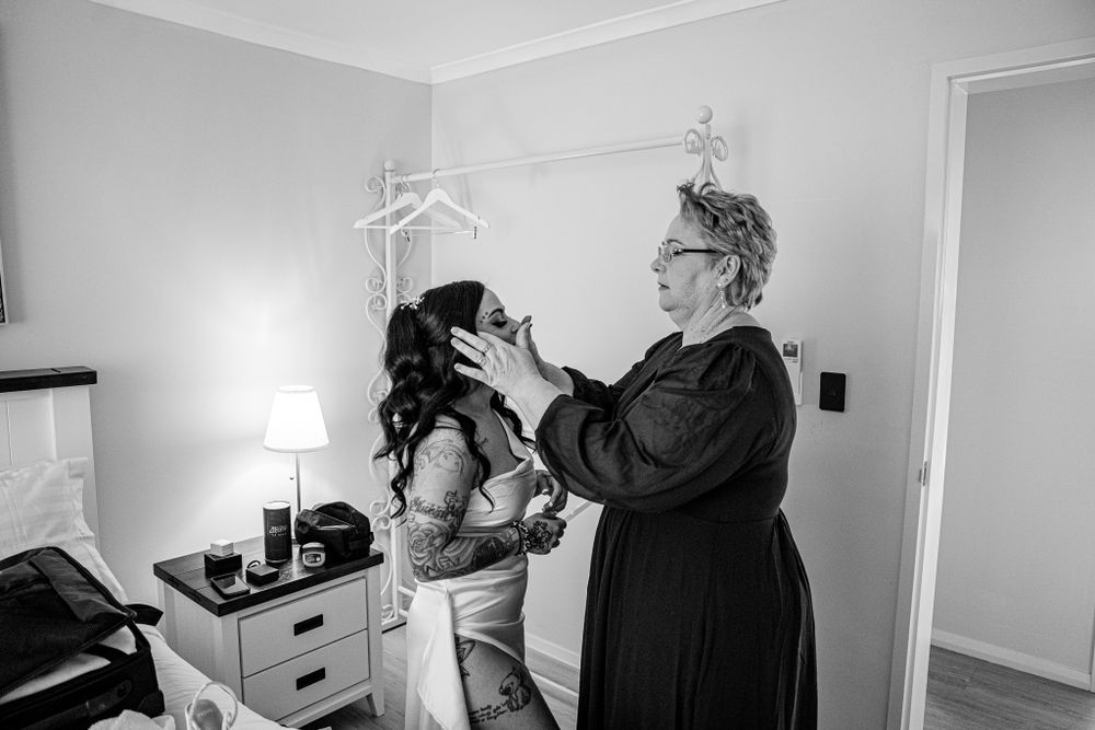 Getting ready scene in bright room with final touches being applied.
