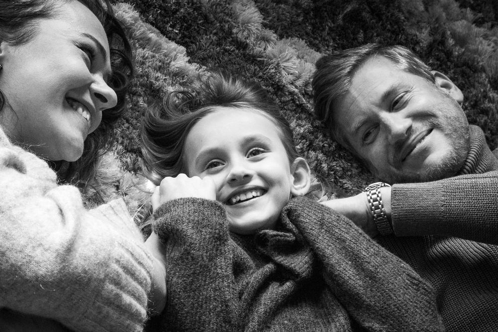 Family on the carpet in a festive mood.