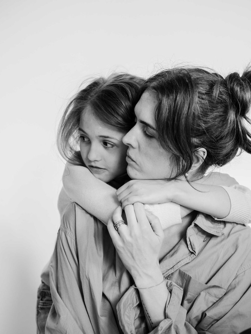 Mother and daughter are hugging.