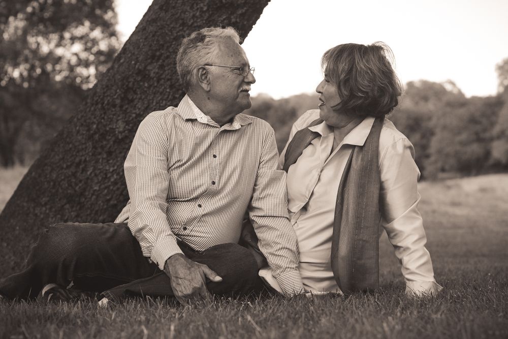 Elderly couples 50th anniversary photography session sitting on grass