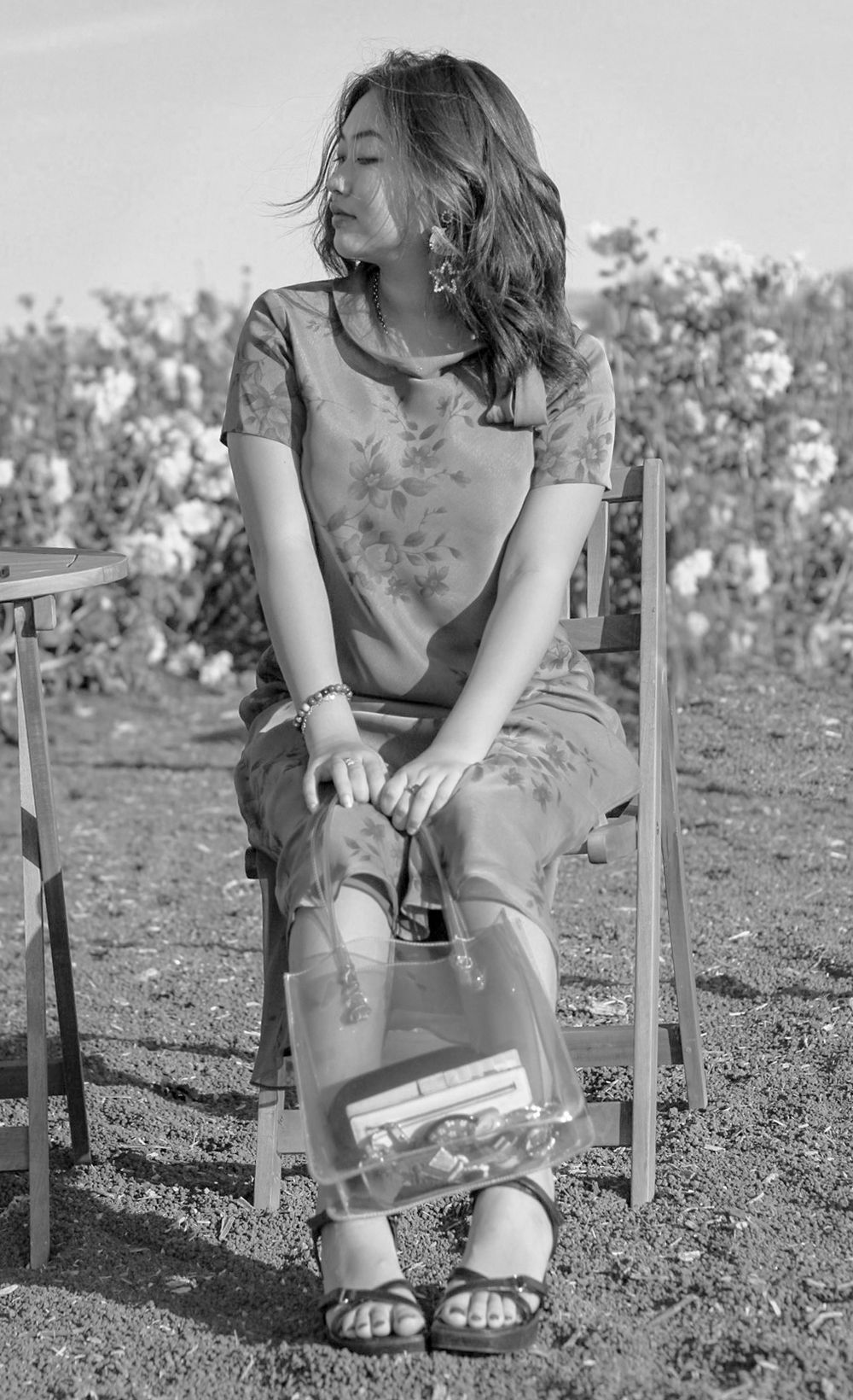 Senior posing on chair for graduation invites at Green Bluff flower farm Eastern Washington
