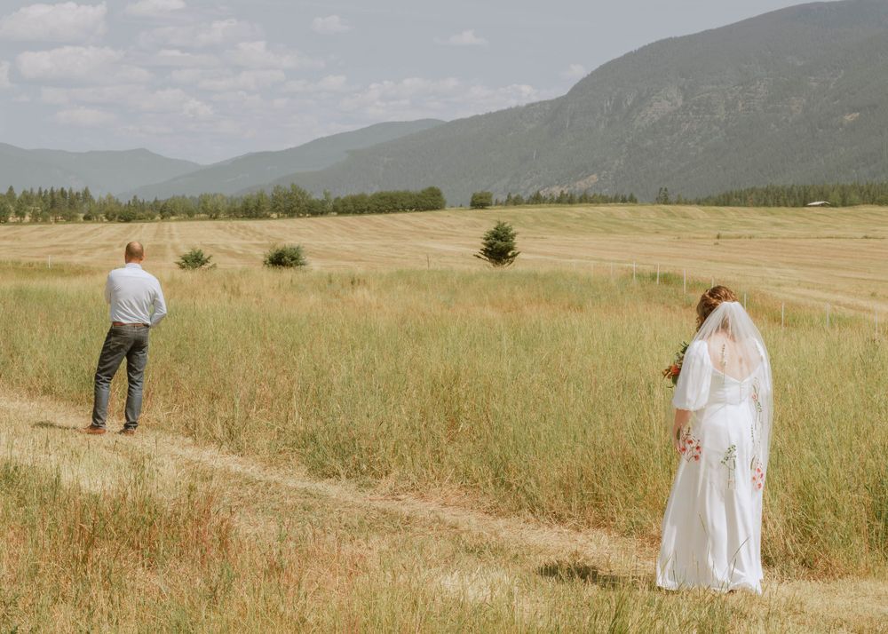 Bride and father for first look mountain shot on wedding day in Bonners Ferry Canadian Border