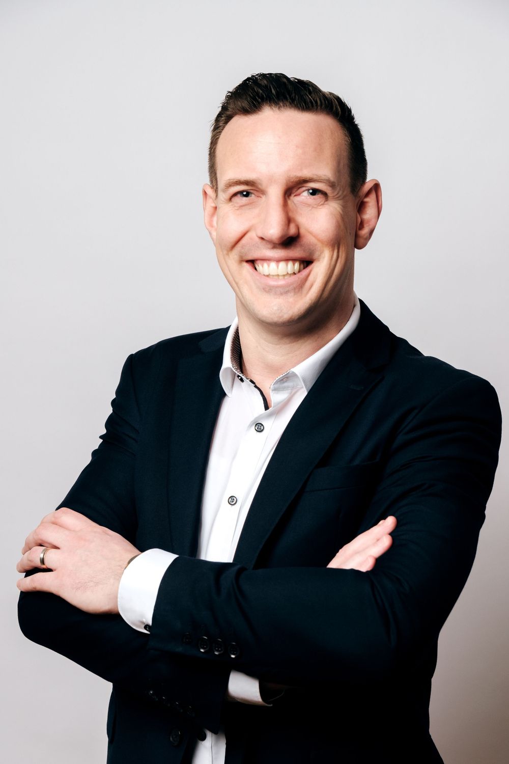 Business portraits showing warm smiles and professional poses against a white backdrop.