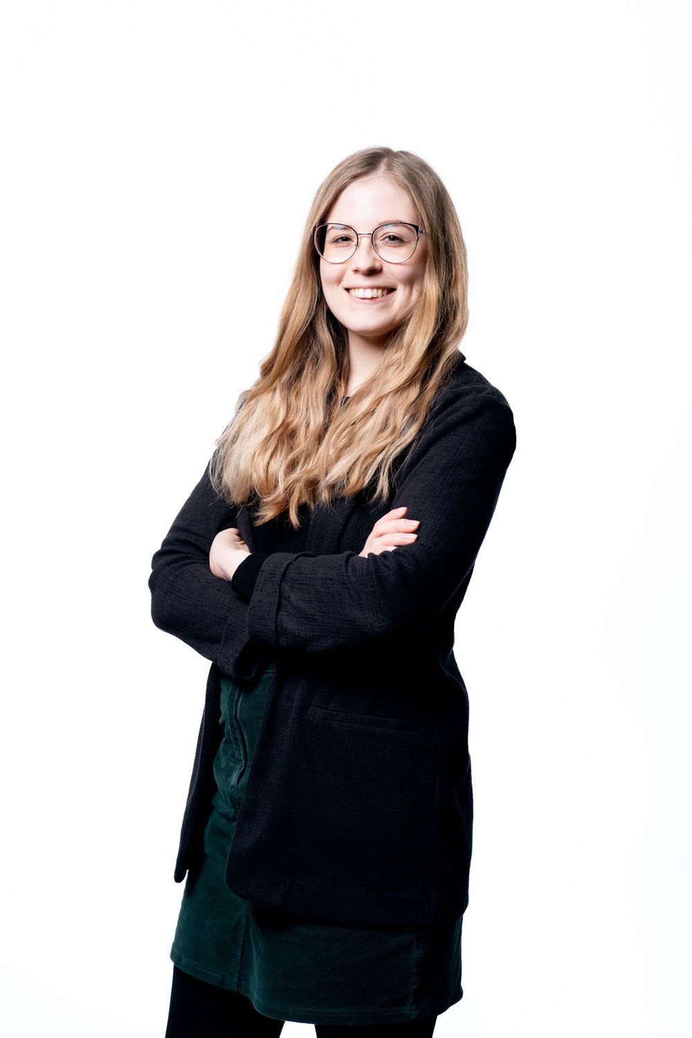 Professional portrait of person in black cardigan and glasses against white background.