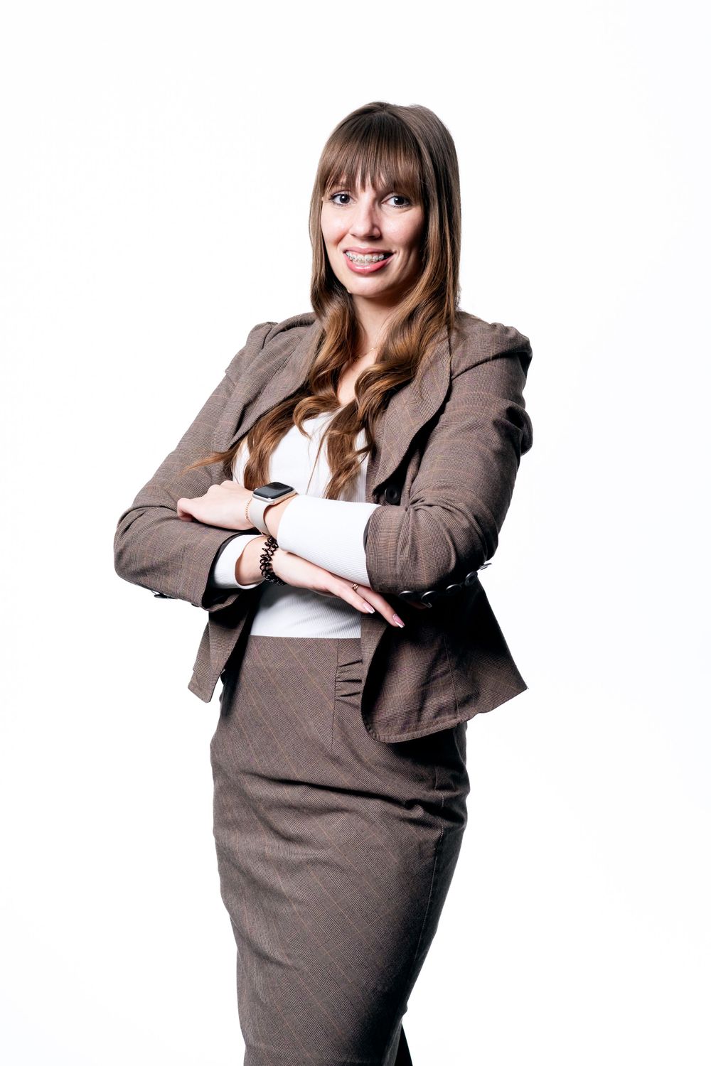 Professional headshot of person in grey business suit against white background.