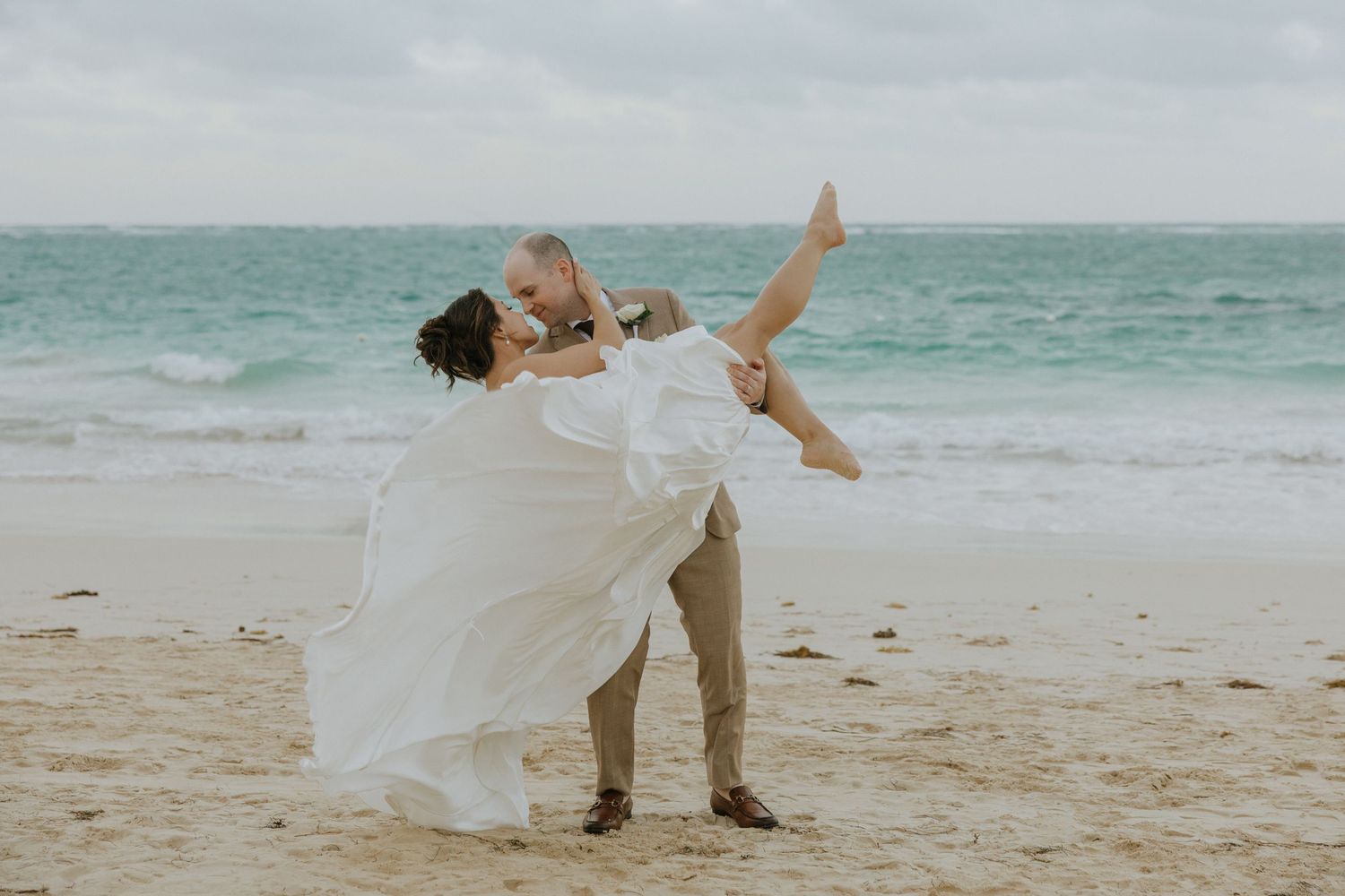 Intimate window-lit portraits create soft silhouettes of wedding couple.