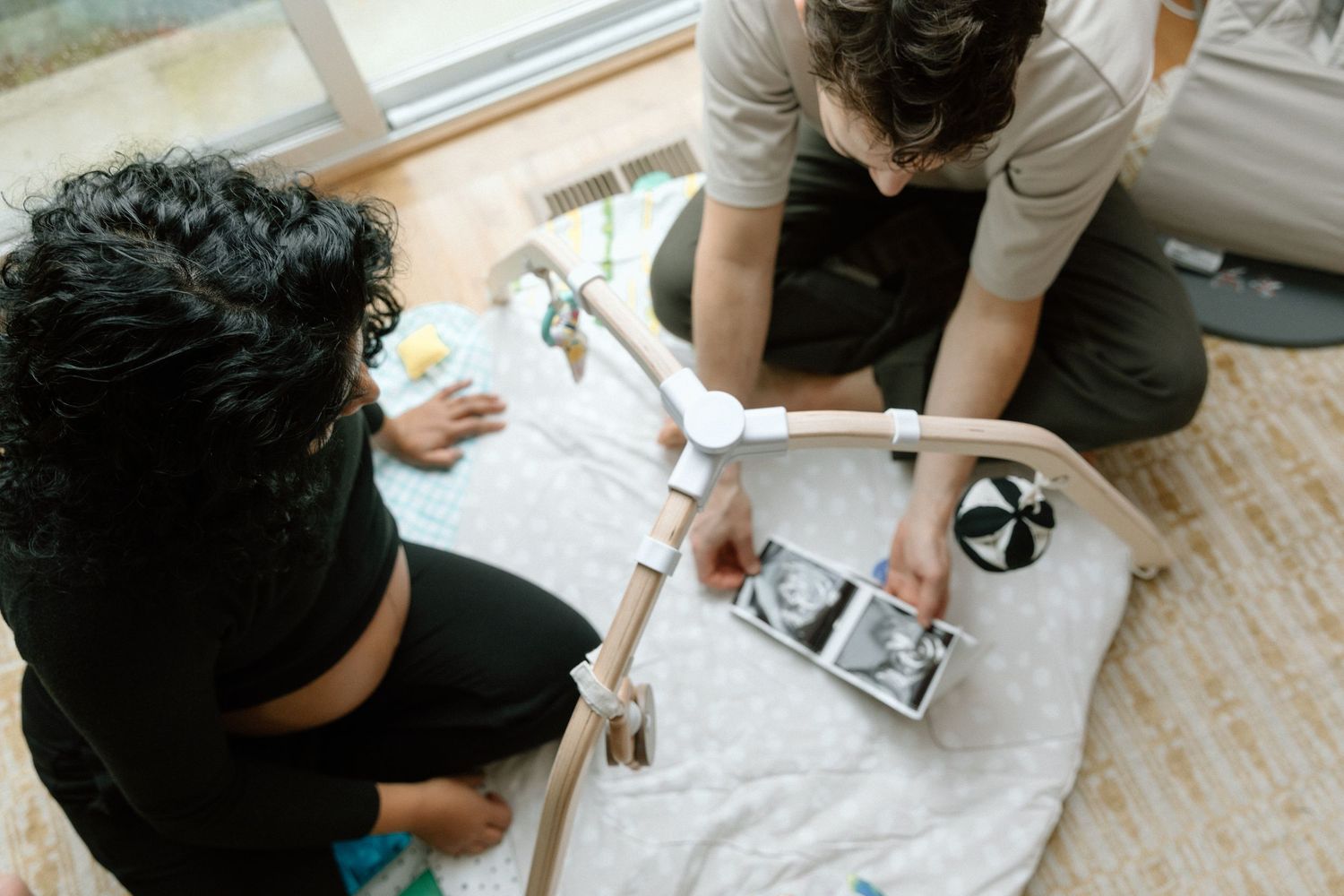 People gathered around a table working on an art or craft project with paper and supplies spread out on the surface.