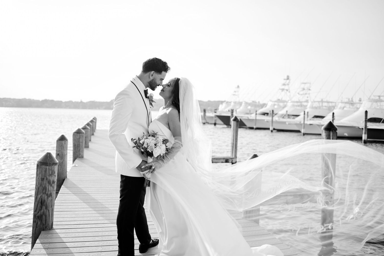 Romantic couple embraces on a stone-lined garden path at Nanina's At The Park wedding venue. Gricel's Photography based in Nutley, NJ