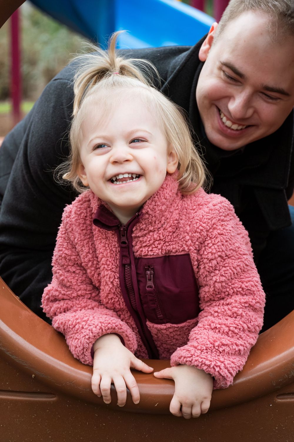 A joyful moment captured of playful interactions on brown leather furniture.