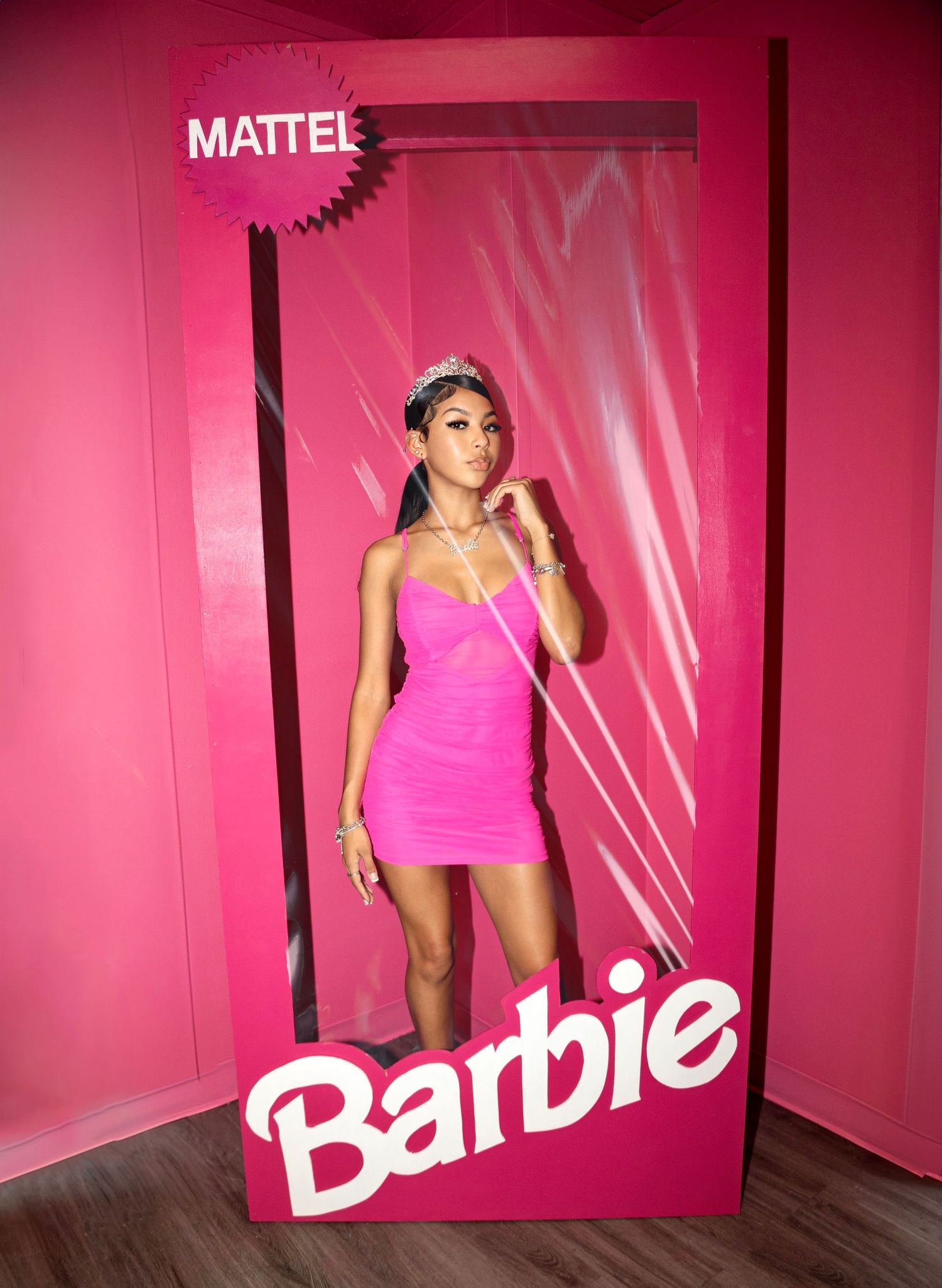 Pink Mattel Barbie box display setup against pink wall in retail environment.