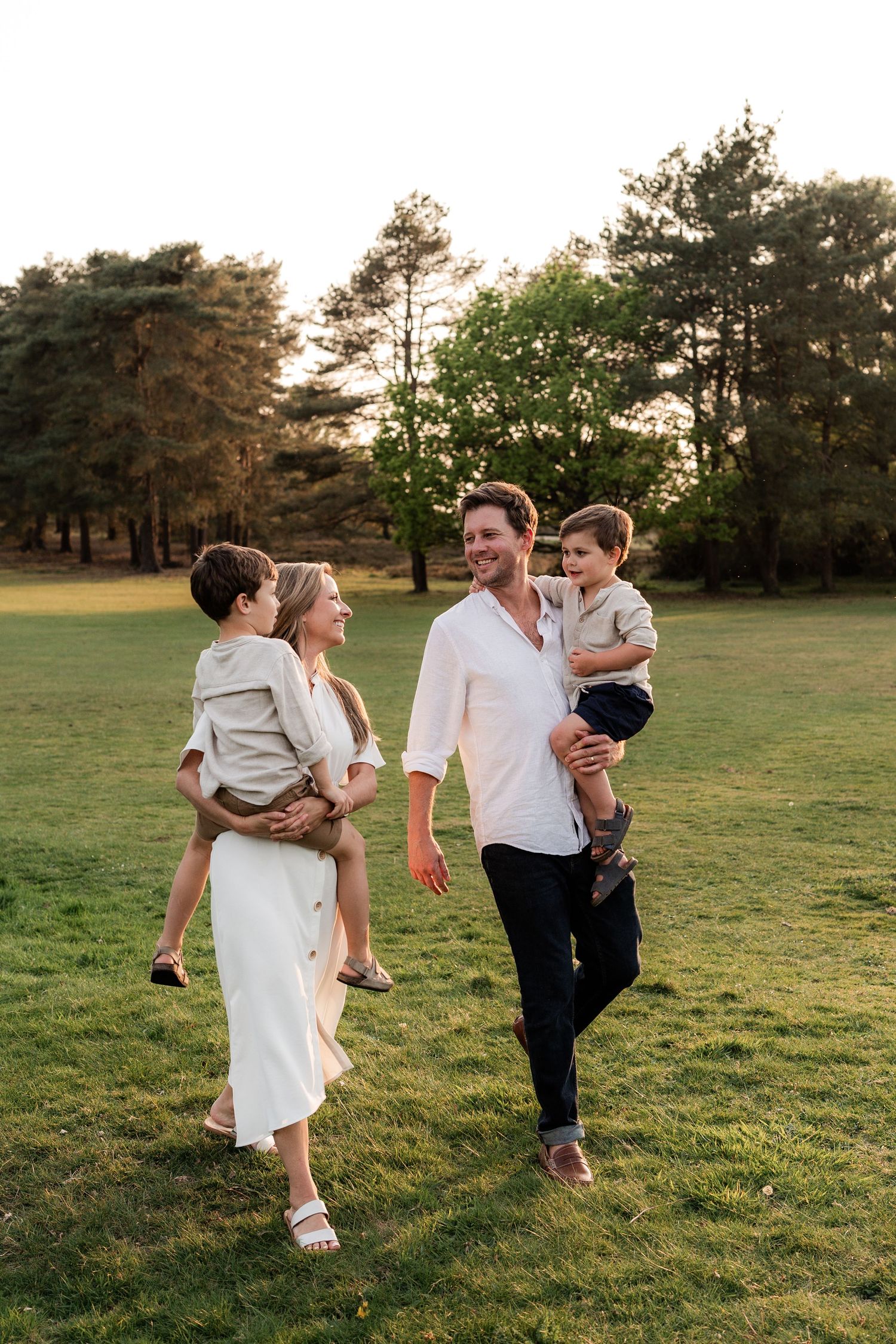 family walking through reigate heath at golden hour