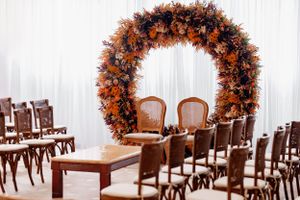 This photo captures rows of wooden chairs arranged for an event inside a modern venue.