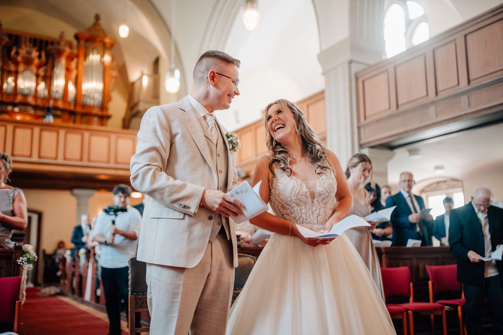 Joyful couple celebrating during their wedding ceremony in a historic church. Hochzeit Hanau
