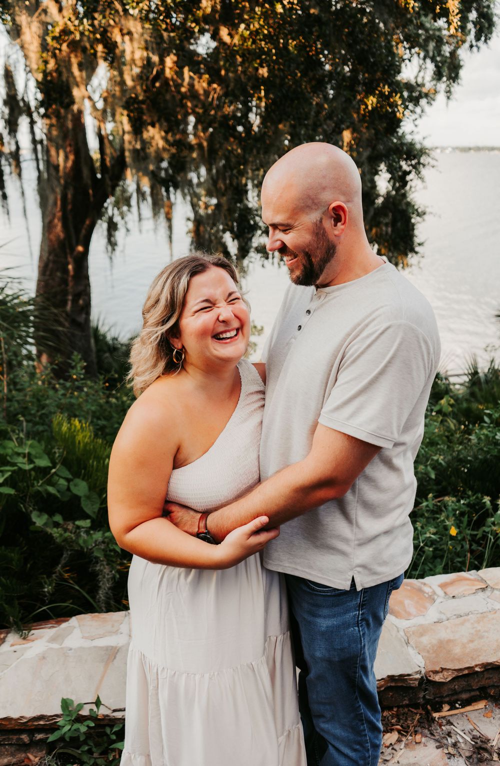Outdoor Family Session Philippe Park in Safety Harbor, FL; couple embracing and laughing