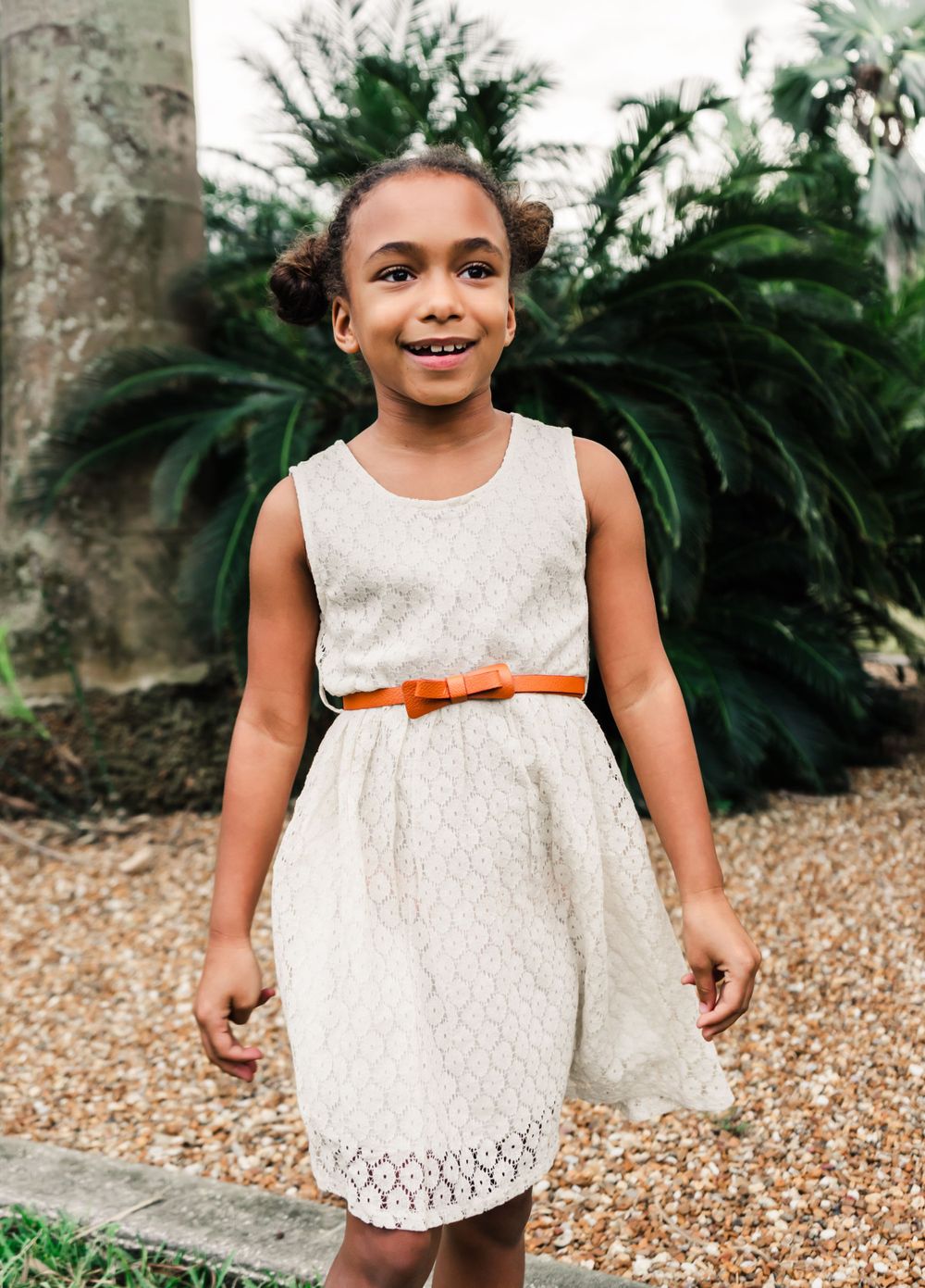 Outdoor Family Session Gisela Kopsick Arboretum in Saint Petersburg, FL; young girl posing near rocks