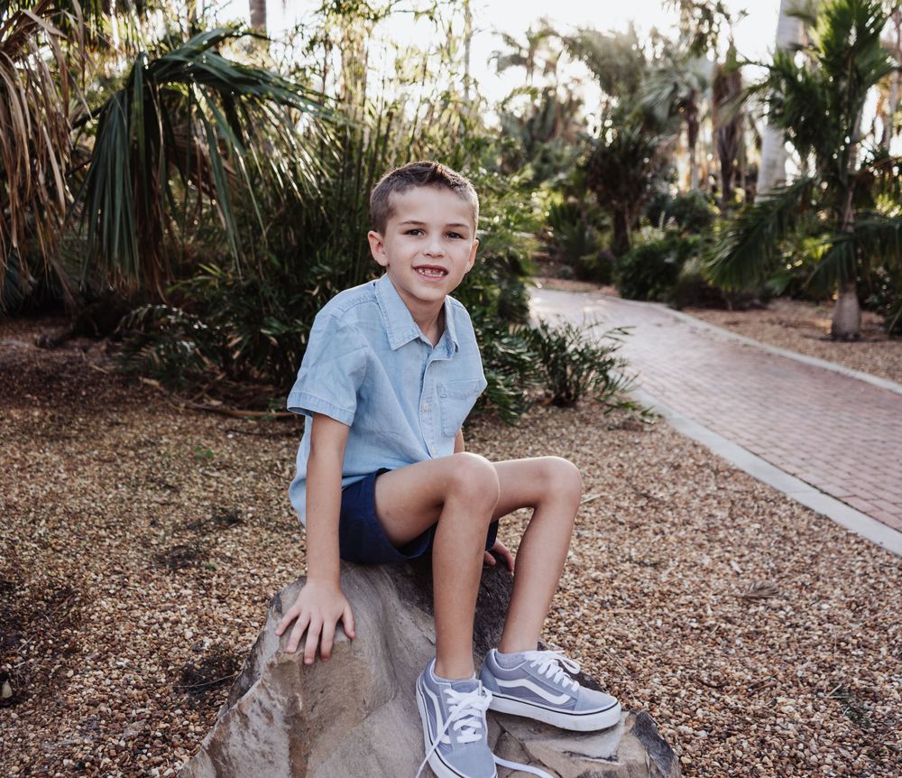 Outdoor Headshot Session Gisela Kopsick Arboretum in Saint Petersburg, FL; Young boy posing on a rock