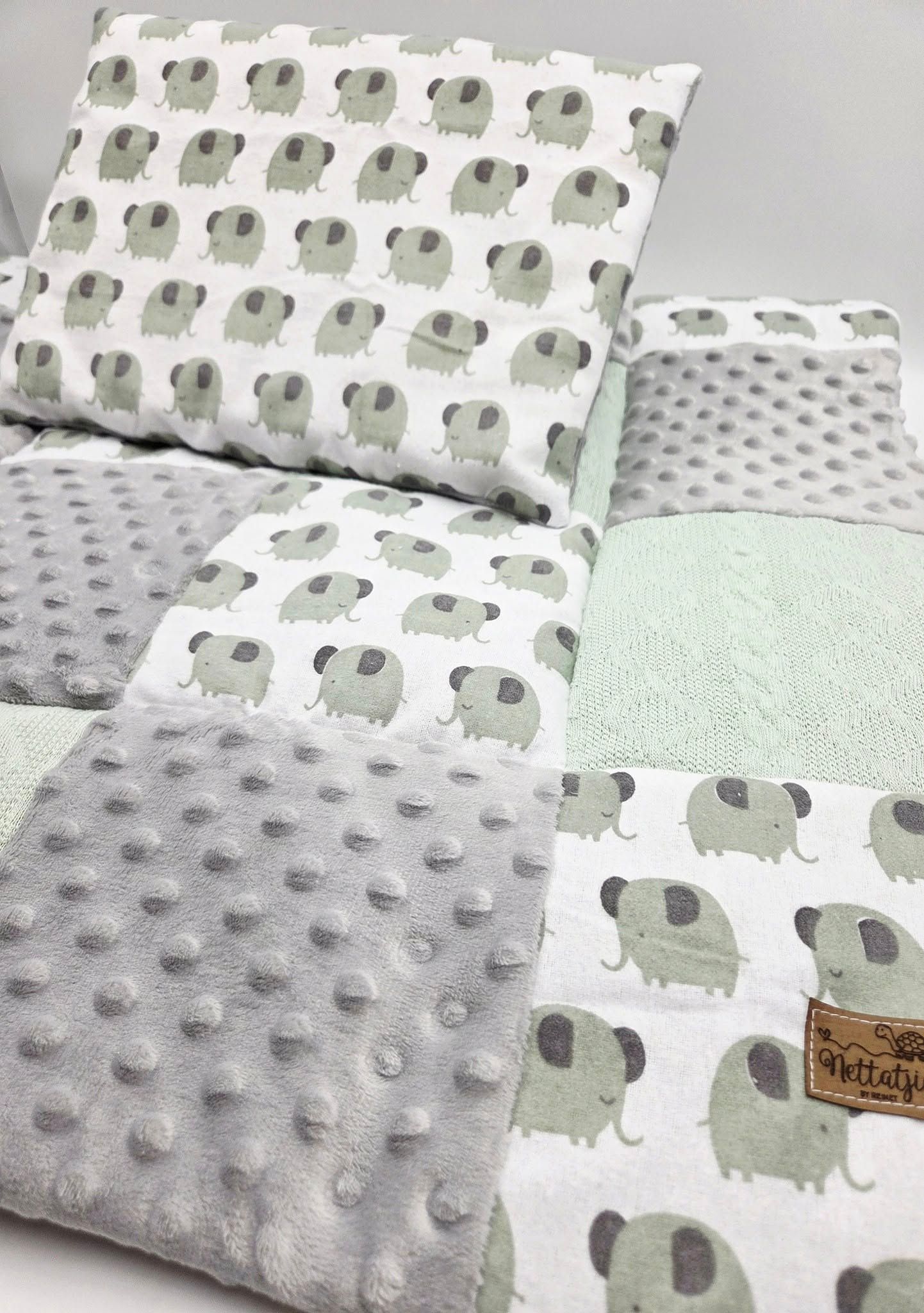 Gray and mint green patchwork baby blanket with elephant print pattern.
