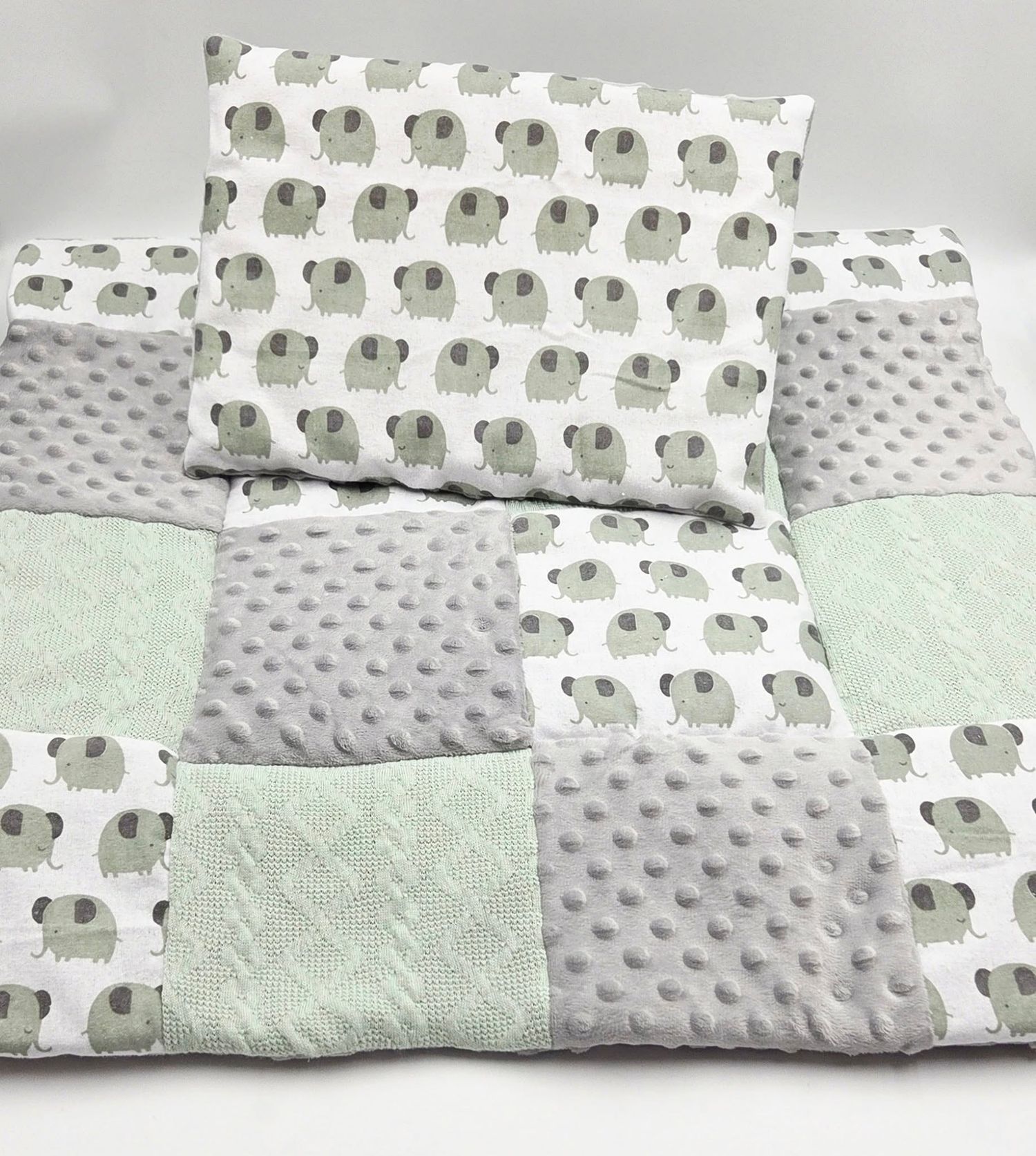 Mint and gray patchwork blanket featuring elephant print fabric and minky texture.