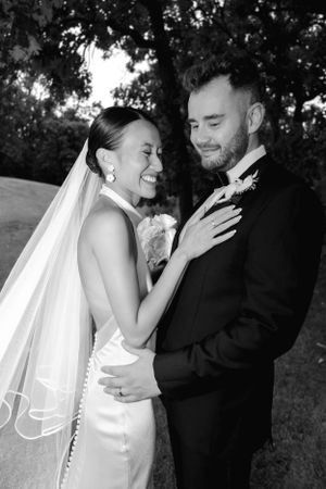 Black and white portrait of a couple sharing an intimate moment during their wedding photoshoot.
