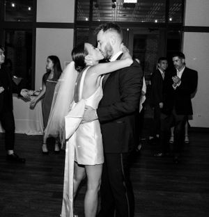 Black and white photo of a couple sharing an intimate dance moment at their luxury wedding reception.
