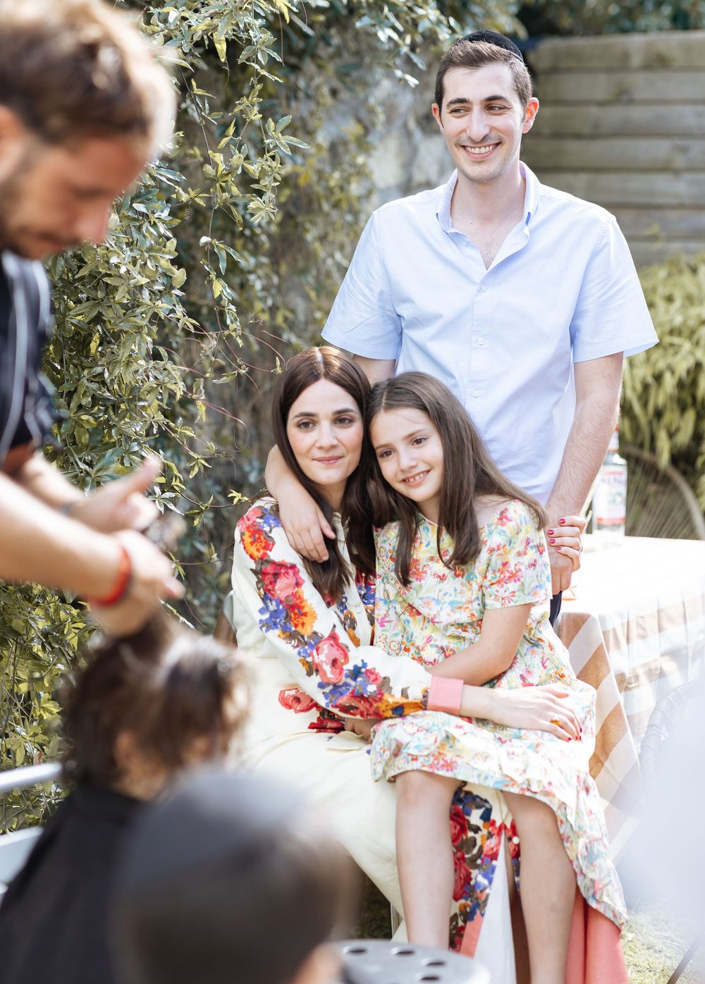 Family enjoying quality time together outdoors in a candid photo series with natural lighting and casual poses.