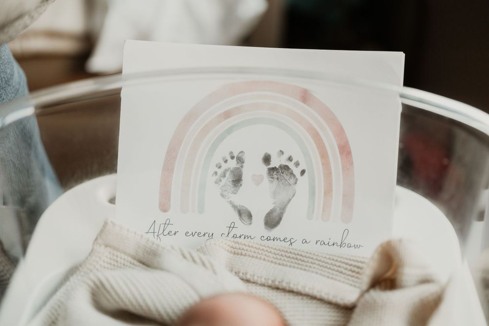 Artistic rainbow-themed nursery decor and wall art in soft pastel colors.