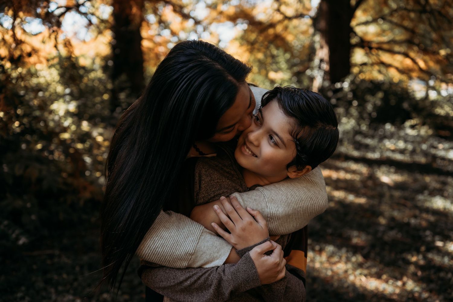 Romantic couple sharing intimate moments in sunlit wooded area. mommy and me