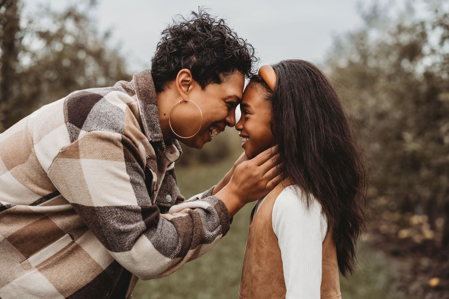 Couple sharing tender moments during outdoor autumn photoshoot. mommy and me