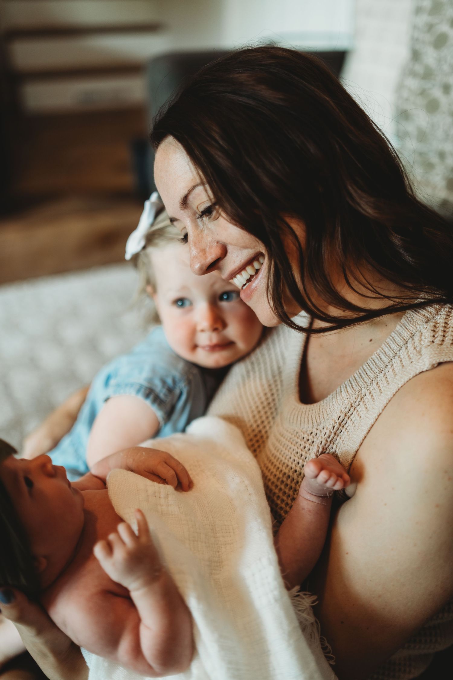 Intimate close-up moments between parent and baby in soft natural light.