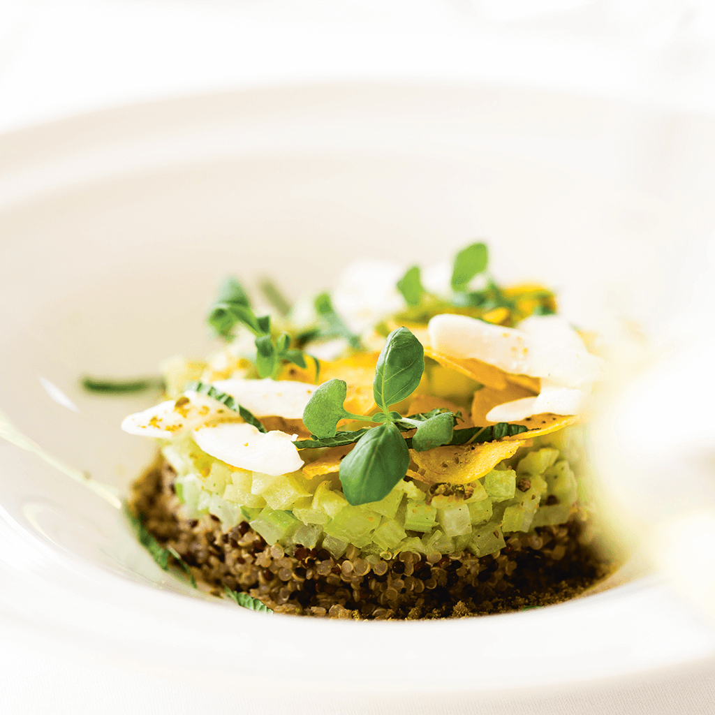 Close-up progression shots of an artfully plated avocado toast with microgreens on white plates.