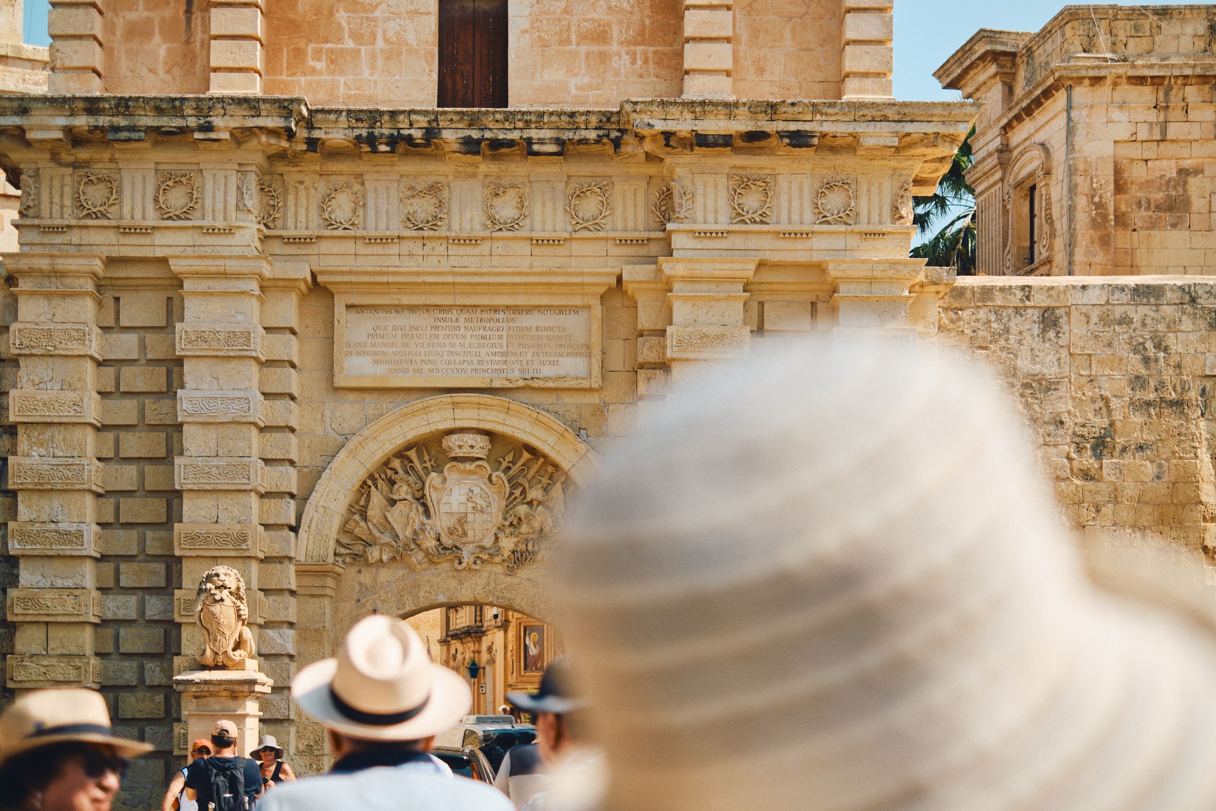 Historic stone archway with motion-blurred movement in foreground.