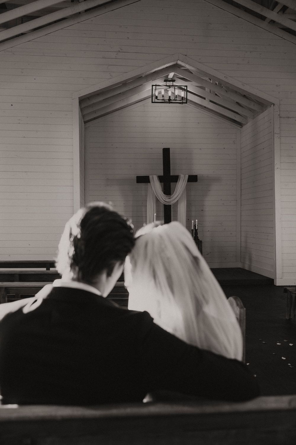 A sequence of black and white photographs showing people lying down in church pews.