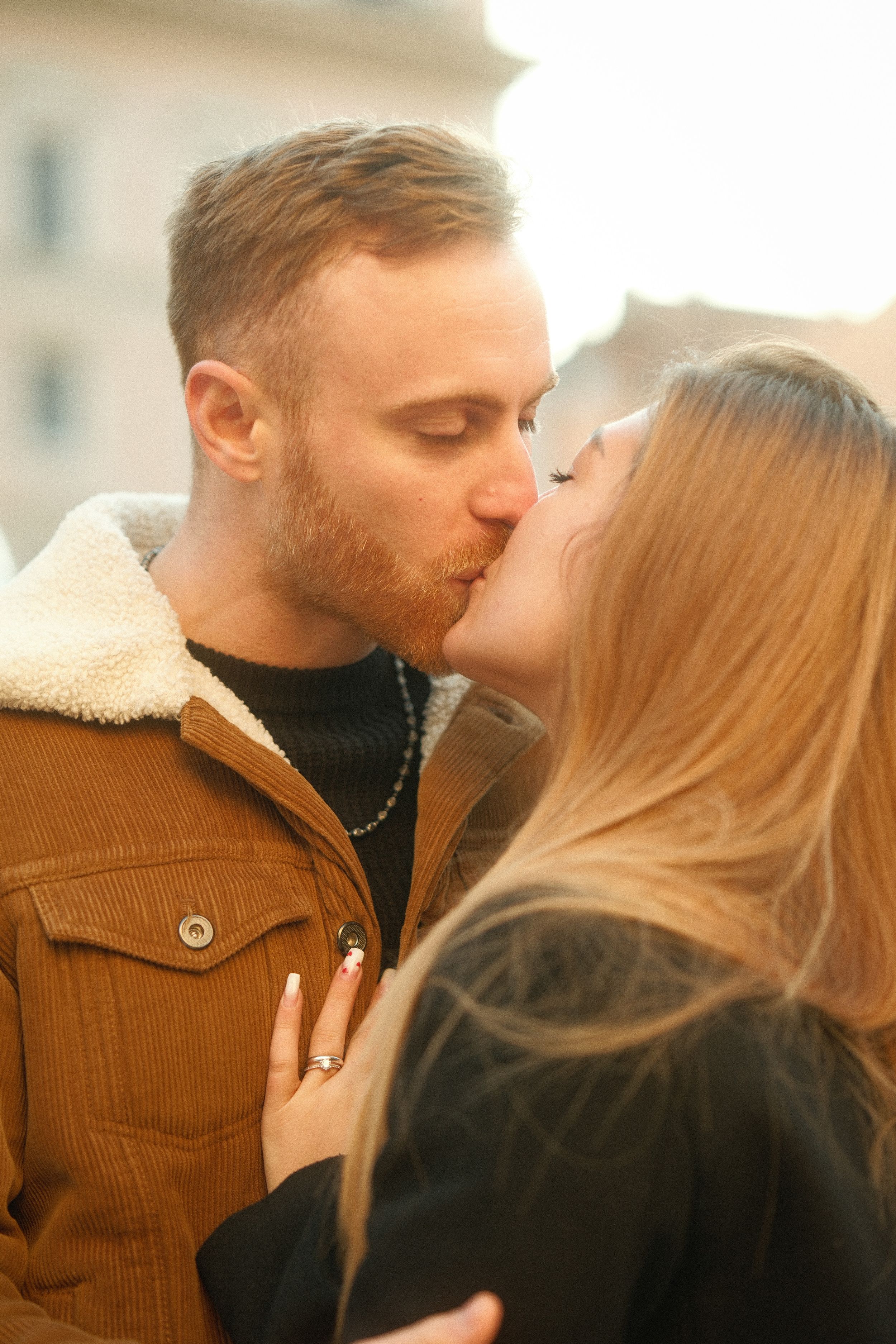 A tender kiss shared in golden hour light.