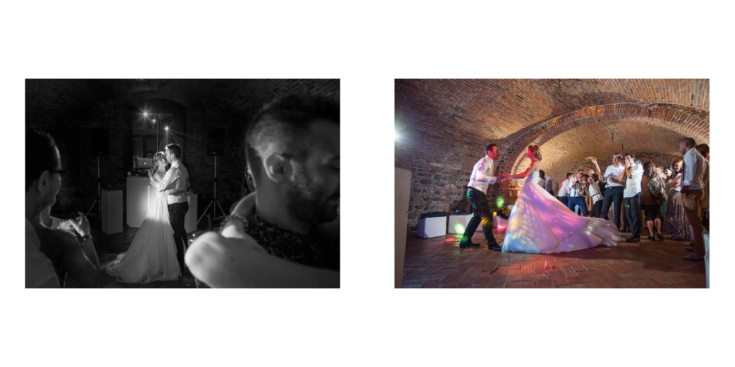 Wedding party dancing and celebrating during an evening reception in a dimly lit venue.