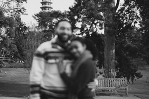 Blurred black and white photo with a pagoda visible in the background.