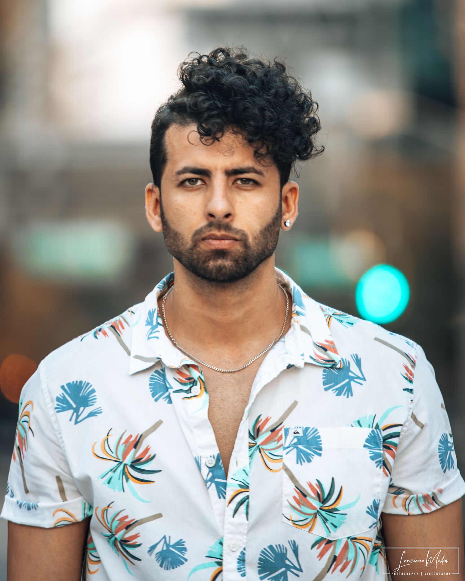 Stylish floral shirt with blue and orange tropical pattern.