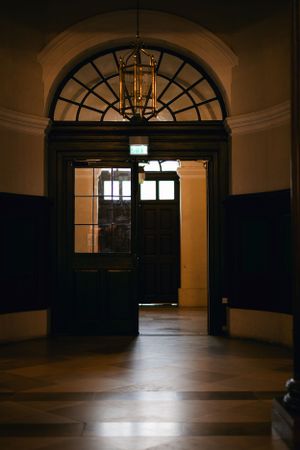 A dramatic archway entrance with a fanlight window and dark wooden doors.