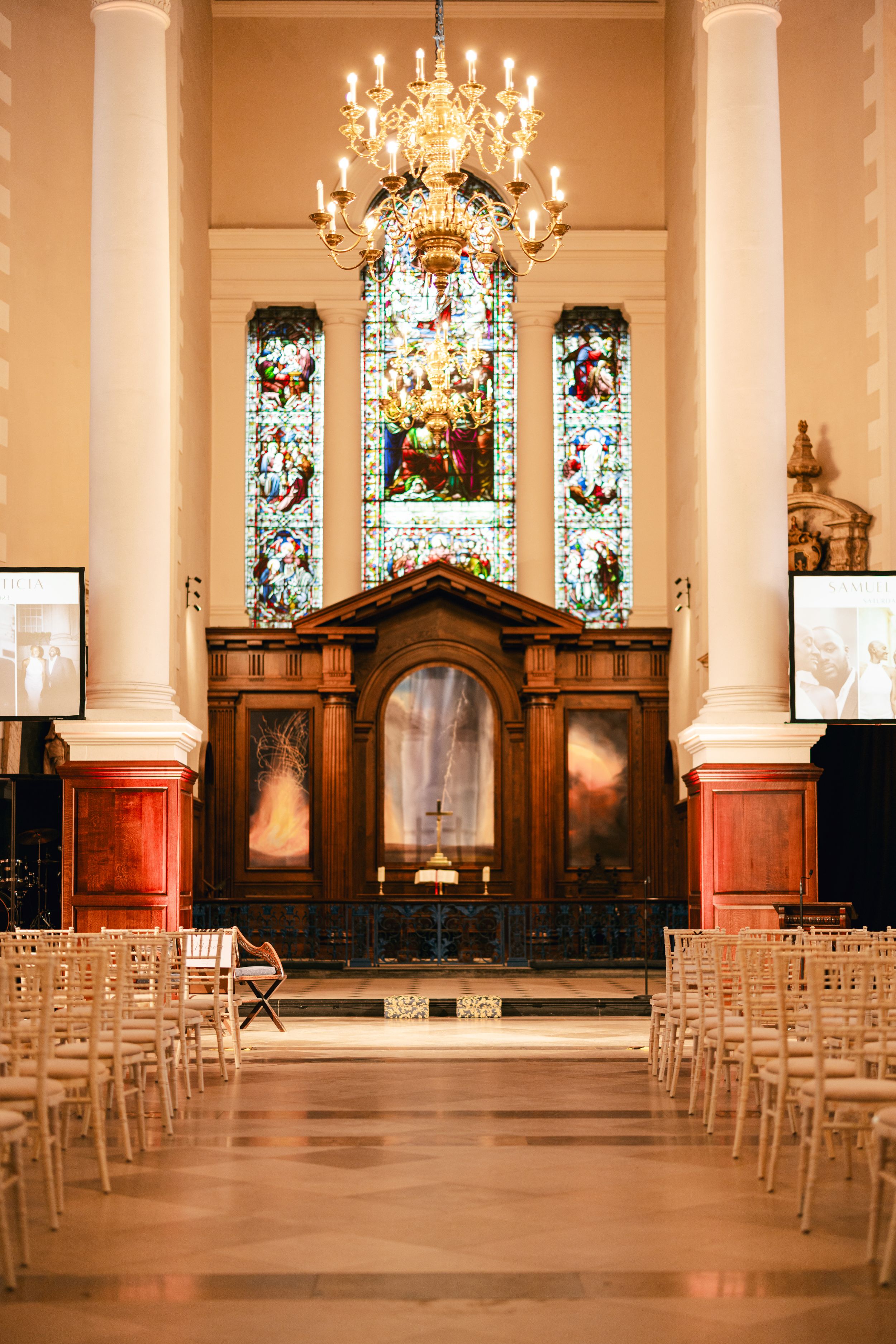 Beautiful church interior with stained glass windows and chandelier for a wedding ceremony.