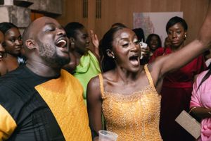 Energetic wedding guests dancing and singing with pure joy at a celebration.