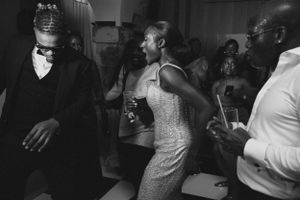 People dancing and socializing at a lively black and white party.