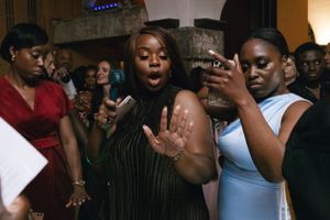Energetic partygoers dancing and singing at a lively celebration.