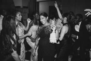 Candid black and white shot of people dancing at a festive party.