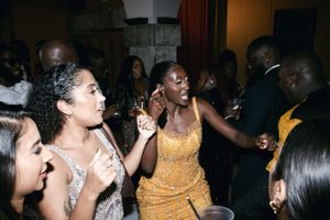 Wedding guests dancing and celebrating at an energetic reception party.