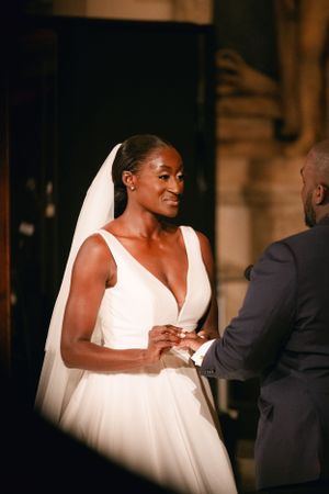 A couple shares a special moment during their wedding ring exchange ceremony.