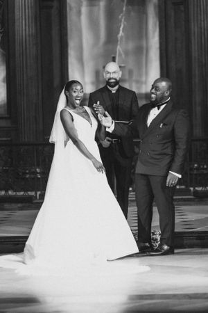 A joyful moment captured in black and white during a wedding ceremony.